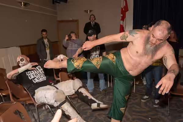 Necro Butcher (right) hitting a superkick on a seated Warhed at an independent show in London, ON (2014)