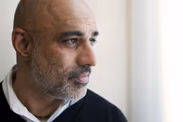Close-up portrait photograph of actor Faran Tahir, facing right, by the US State Department in an article about his career. (2016)