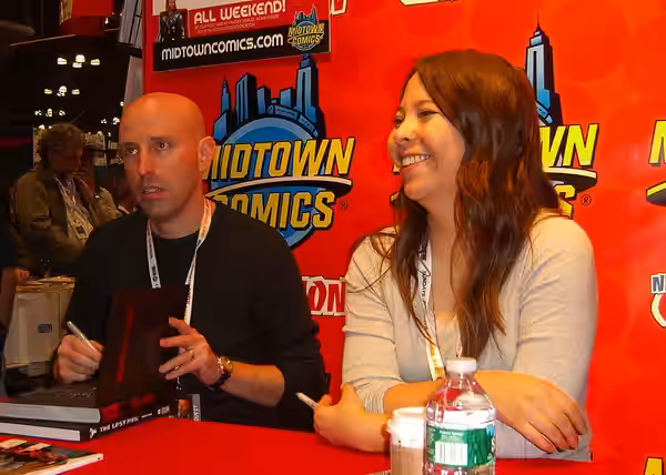 Writer Brian K. Vaughan and artist Fiona Staples, the co-creators of the comic book series Saga, at the Midtown Comics booth on Day 2 of the 2012 New York Comic