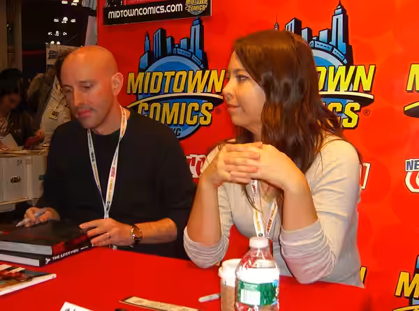 Writer Brian K. Vaughan and artist Fiona Staples, the co-creators of the comic book series Saga, at the Midtown Comics booth on Day 2 of the 2012 New York Comic
