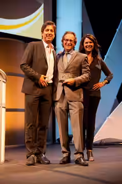 Jason Katims is presented with his Career Achievement Award by award presenters Lauren Graham and Ray Romano during the 2014 Voice Awards held on August 13 at R