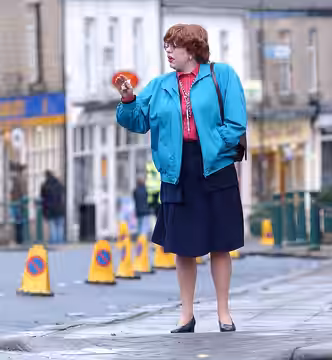Steve Pemberton acting as Pauline during the filming of The League of Gentlemen's Apocalypse on Station Road in Hadfield, Derbyshire, England in 2004 (2010)