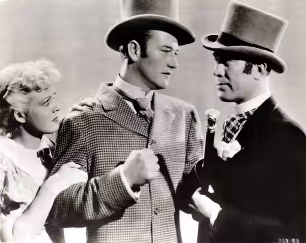 L. to R. : Jean Rogers, John Wayne &amp; Ward Bond in Conflict - publicity still (cropped) (1936)