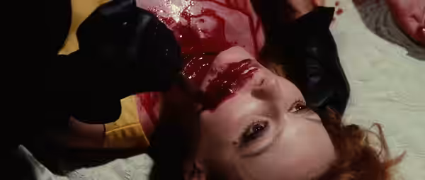 Black-gloved killer murdering a victim in Death Walks on High Heels (1971)