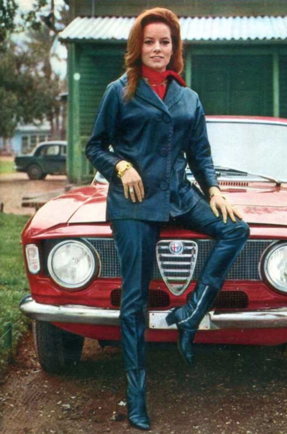 Italian actress Luciana Paluzzi sitting on the hoods of an Alfa Romeo Giulia GT, circa 1966.