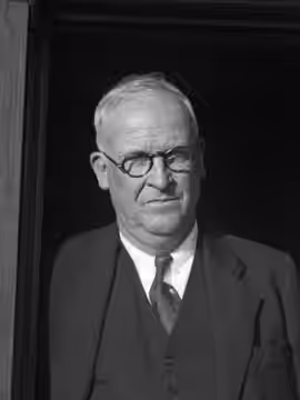 Harry Carr, Los Angeles Times reporter, editor and columnist, standing in a doorway with hat in hand at the port in San Pedro upon his return from a trip to Eur (1934)