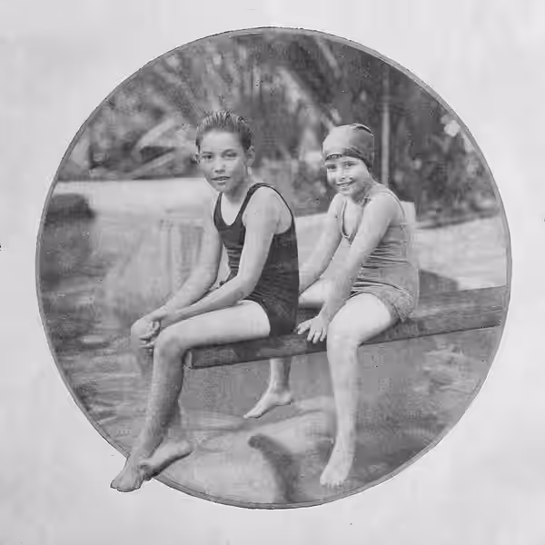 Carter DeHaven Jr, and Marjorie Florence DeHaven, children of Mr. and Mrs. Carter DeHaven, sitting on diving board (1922)