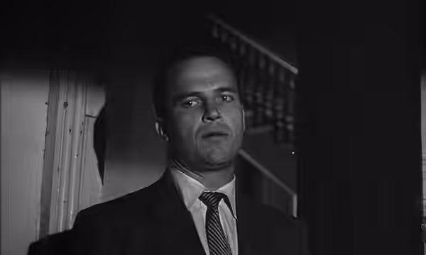 Screenshot of Ralph Meeker as Mike Hammer from the trailer for the film noir Kiss Me Deadly. (1955)