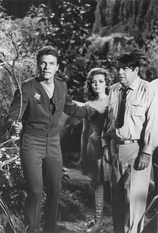 Publicity photo of television actors Gary Conway, Deanna Lund and Kurt Kasznar promoting their roles on the television series Land of the Giants.