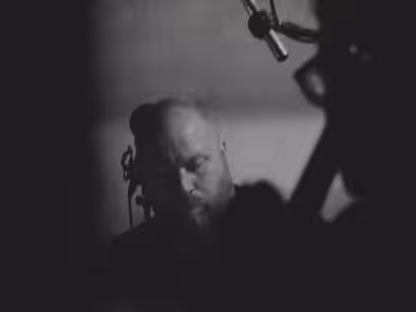 This is a photo of Icelandic neoclassical composer Jóhann Jóhannsson during a live score/screening of Bill Morrison's "The Miners Hymns". (2014)