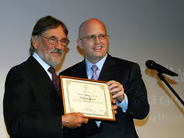 Philip T. Reeker, US Ambassador to Macedonia, presenting the Cultural Diplomacy Award to cinematographer Vilmos Zsigmond on stage at the Closing Ceremony. Manak (2010)