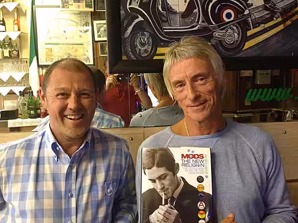 Paul Anderson and Paul Weller, with Anderson's book 'Mods: The New Religion'. (2019)