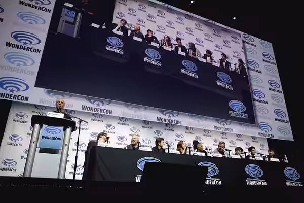 Scott Mantz, Ernest Cline, Zak Penn, Tye Sheridan, Olivia Cooke, Lena Waithe, Ben Mendelsohn, Philip Zhao and Win Morisaki speaking at the 2018 WonderCon, for "