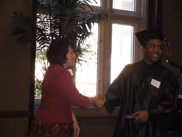 Christopher Massey graduating High School. The woman is the principal handing him a pen as a gift of the school. He should have received the diploma previously. (2008)