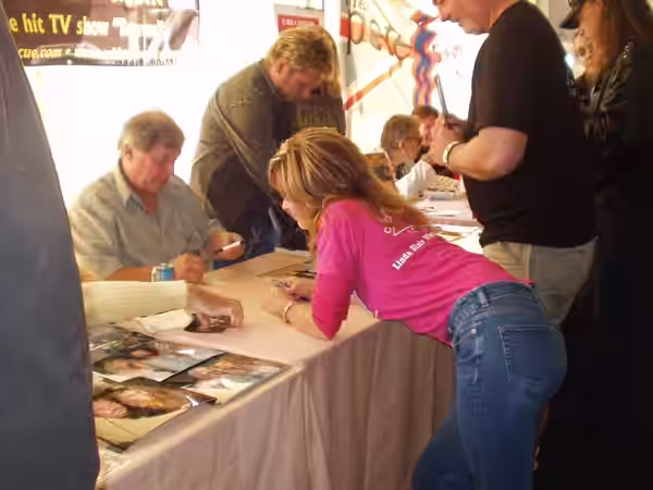 Linda Blair talking to Burt Ward in 2005.