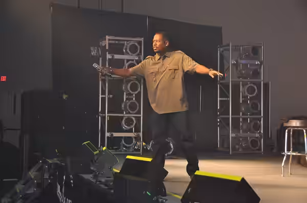 Photograph of Martin Lawrence holding the microphone to an audience of US Air Force troops at Centennial Banquet and Conference Center East Fort Bliss Texas as  (2011)