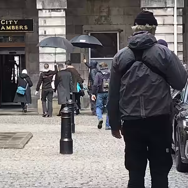 Film crews outside the City Chambers in Edinburgh. Matthew Goode is wearing the brown coat. (2024)