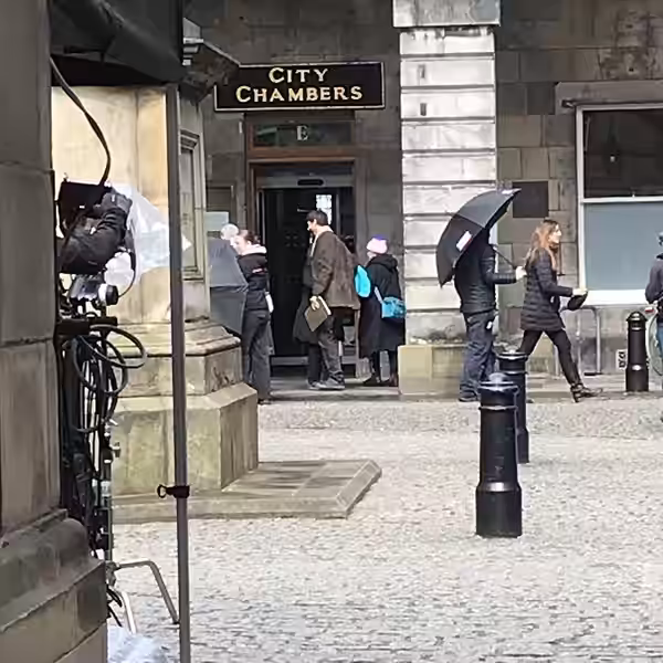 Film crews outside the City Chambers in Edinburgh. Matthew Goode is wearing the brown coat. (2024)