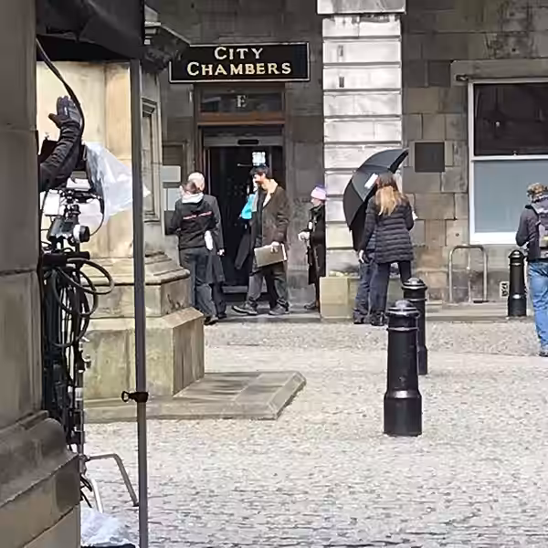 Film crews outside the City Chambers in Edinburgh. Matthew Goode is wearing the brown coat. (2024)