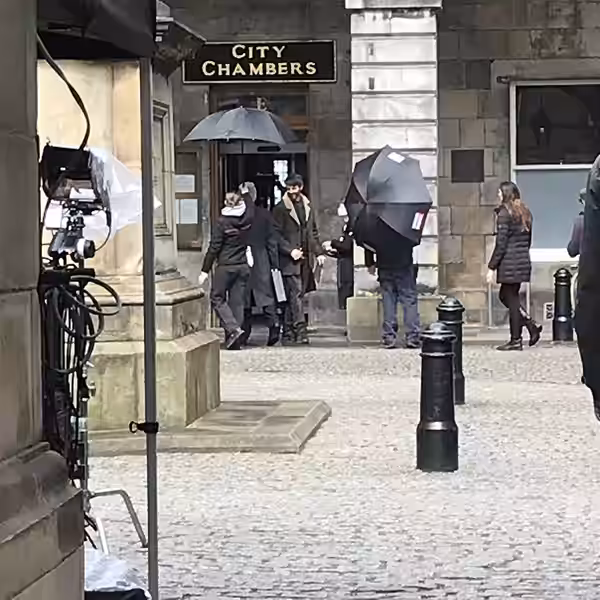 Film crews outside the City Chambers in Edinburgh. Matthew Goode is wearing the brown coat. (2024)