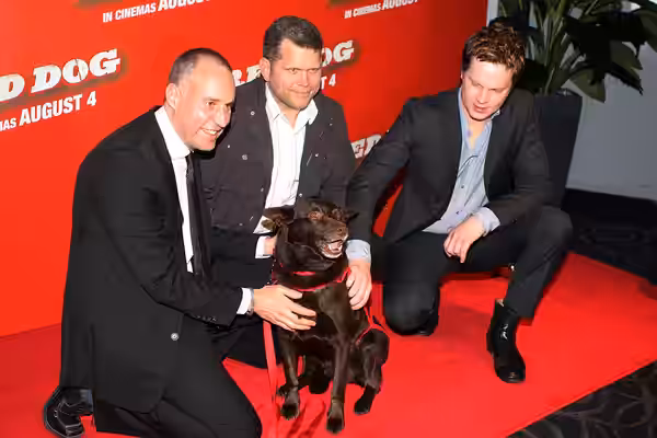 L to R: w:Nelson Woss, w:John Batchelor (actor), w:Luke Ford (actor) and Koko the red cloud kelpie at the Red Dog premiere in Sydney. (2011)