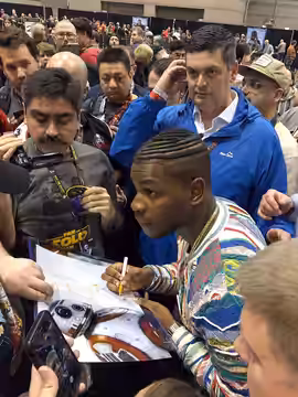 John Boyega signs autographs on the convention floor at Star Wars Celebration 2019 in Chicago.