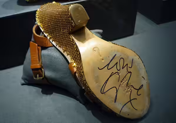 Kylie Minogue has signed 4" brown and gold sequined Moschino wedge sandals, size 3. (2009)