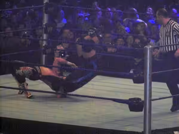 Chavo Guerrero, Jr. and "MVP" wrestling. Guerrero is the one flipping backward parallel to the ring, while MVP lands squarely on his head. (2009)