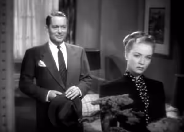 Screenshot from the trailer for Lady in the Lake, featuring Robert Montgomery and Audrey Totter, reflected in a mirror (1947)