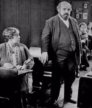 Still from the American drama film We Americans (1928) with George Sidney, on page 16 of the January 28, 1928 Universal Weekly.