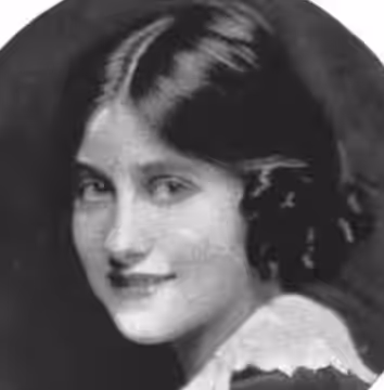 A smiling young white woman with dark hair parted center, wearing a white lace collar (1920)