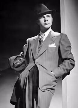 A 1949 publicity photo of Dick Powell, costumed as Richard Diamond, Private Detective.
