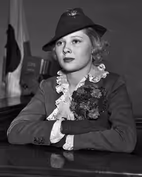 Actress Mary Carlisle sits in the witness box with her arms folded. She describes the great personal distress she felt upon accidentally striking down surveyor  (1935)