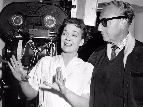 Publicity photo from the set of the 1955 film All That Heaven Allows with actress Jane Wyman and director Douglas Sirk.
