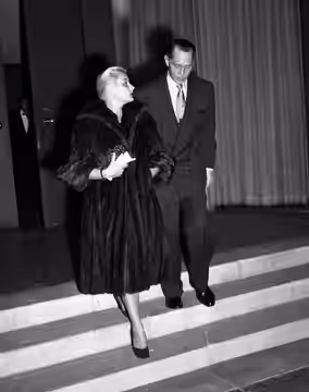 Barbara Payton and Franchot Tone leaving Romanoff's Restaurant in Beverly Hills, California (1951)