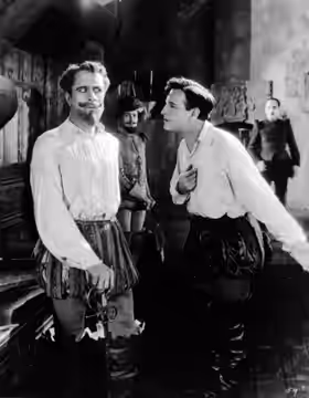 Boyd Irwin and Conway Tearle in Ashes of Vengeance, with unidentified actors in the background (1923)