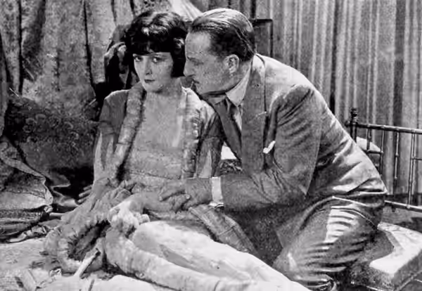 Still from the American crime drama film Midnight Rose (1928) with Lya De Putti and Henry Kolker, on page 13 of the August 27, 1927 Universal Weekly.