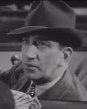 Screenshot of John Litel from the trailer for the film Little Miss Thoroughbred (1938).