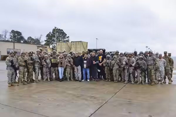 UFC fighters Ben Rothwell, Valentina Shevchenko, and Lorenz Larkin pose for a photo with U.S. Army Soldiers from the 7th Transportation Brigade (Expeditionary)  (2016)