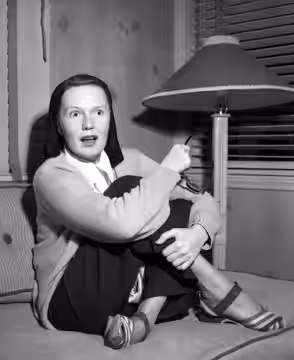 Actress Rita Johnson shown at interview in Balboa Bay apartment (Newport Beach, California) where she is taking a rest after release from a hospital following m (1948)