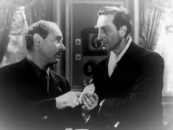 Mikhail Rasumny (left) & Basil Rathbone in the film Heartbeat (1946) - cropped screenshot
