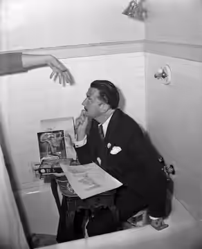Artist Salvador Dali seated in a bathtub at the Ambassador Hotel in Los Angeles (1944)