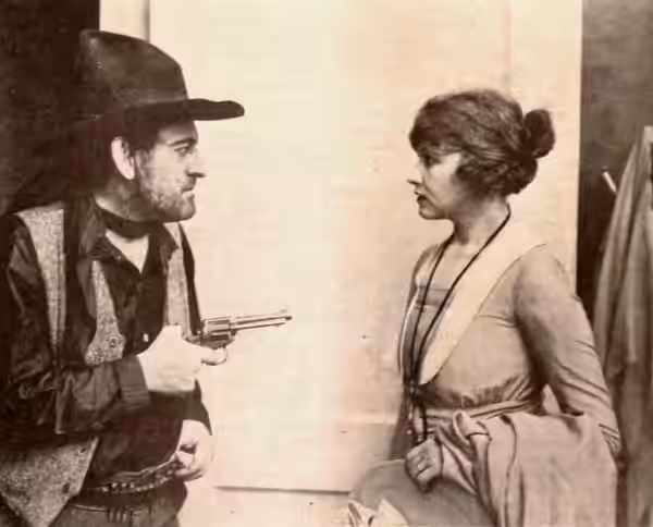 Still from the American western film Heart of the Sunset (1918) with Herbert Heyes and Anna Q. Nilsson, on page 23 of the April 6, 1918 Exhibitors Herald.