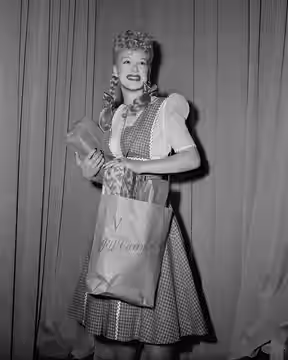 Title: "I'll carry mine." Betty Hutton, popular Paramount Pictures star, jitterbugs to the market and carries home her purchases, cooperating with the "I'll Car