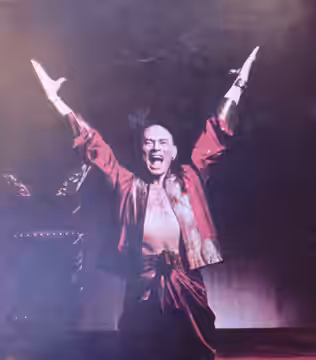 Yul Brynner as the King, from a 1977 souvenir program for The King and I. Lacks any copyright notice, so it is no longer under copyright. Image photographed wit