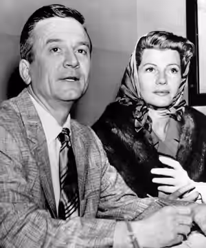 Photograph of Rita Hayworth and James Hill obtaining their marriage license Caption on photograph run in the Cedar Rapids Gazette reads as follows: RITA GETS A  (1958)