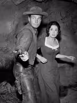Photo of Eric Fleming and Linda Cristal from the television program Rawhide. Gil Favor (Fleming) battles to keep a Spanish countess (guest star Cristal) safe. (1959)