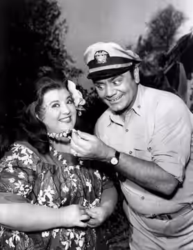 Photo of Ernest Borgnine as McHale and Peggy Mondo as Little Flower, the chief's daughter, from the television program McHale's Navy. (1963)