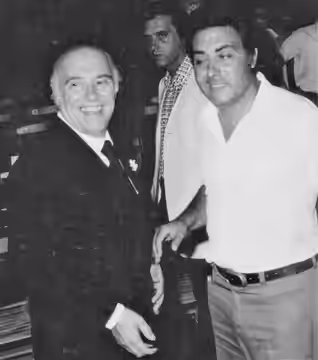 Photograph of the Italian producer Carlo Ponti (to the left) with people at Taormina Film Festival.