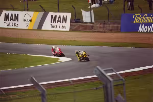Valentino Rossi, riding his Nastro Azzurro Honda, being followed by the Blu Aprilia of Jeremy McWilliams at the 2000 British Grand Prix. (2014)